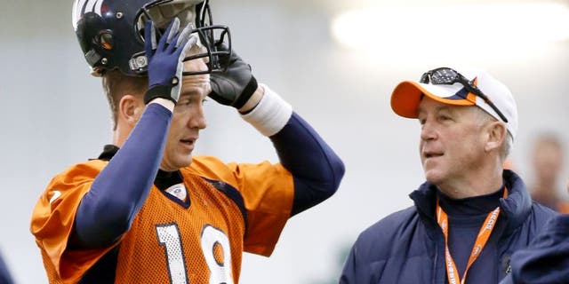 Denver Broncos quarterback Peyton Manning (18) talks with head coach John Fox during practice Thursday, Jan. 30, 2014, in Florham Park, N.J. The Broncos are scheduled to play the Seattle Seahawks in the NFL Super Bowl XLVIII football game Sunday, Feb. 2, in East Rutherford, N.J. (AP Photo)