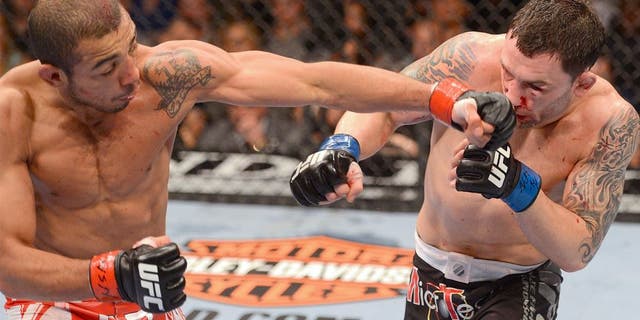 LAS VEGAS, NV - FEBRUARY 02: (L-R) Jose Aldo punches Frankie Edgar during their featherweight title fight at UFC 156 on February 2, 2013 at the Mandalay Bay Events Center in Las Vegas, Nevada. (Photo by Donald Miralle/Zuffa LLC/Zuffa LLC via Getty Images)