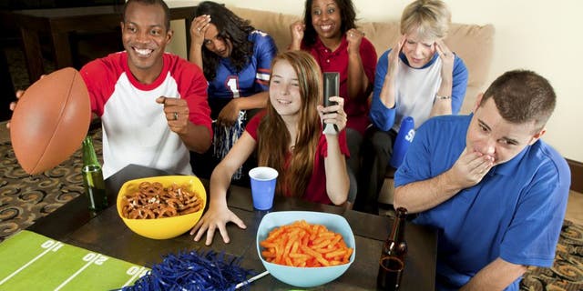 Diverse Group of Family and Friends Watching a Football Game