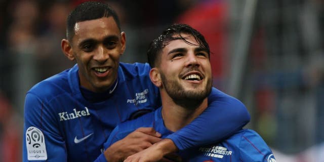 Caen's French forward Andy Delort (R) is congratulated by Caen's French forward Ronny Rodelin after scoring a penalty kick during the French L1 football match between Caen (SM Caen) and Nice (OGC Nice) on January 31, 2016 at the Michel d'Ornano stadium in Caen. AFP PHOTO / CHARLY TRIBALLEAU / AFP / CHARLY TRIBALLEAU (Photo credit should read CHARLY TRIBALLEAU/AFP/Getty Images)