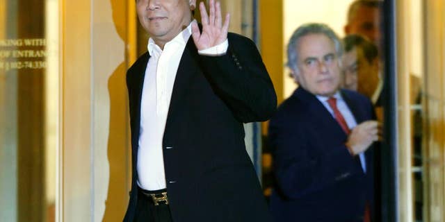 FILE- In this Oct. 26, 2015 file photo, Chinese billionaire Ng Lap Seng waves to the media as he leaves federal court after he was released on bail in connection with a United Nations bribery scheme in New York. Jurors in Ng's trial should know he was referred to as the "boss" by co-conspirators, prosecutors said Friday, Dec. 30, 2016, as they argued that defense lawyers were "far-fetched" to say the word suggests organized crime. (AP Photo/Kathy Willens, File)