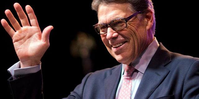 Aug. 7, 2015: Republican presidential candidate, former Texas Gov. Rick Perry, waves to the crowd as he steps to the podium to speak at the RedState Gathering in Atlanta.