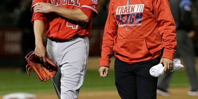 Los Angeles Angels pitcher Garrett Richards, left, leaves the field with a trainer after being relieved during the fifth inning of the team's baseball game against the Oakland Athletics in Oakland, Calif., Wednesday, April 5, 2017. (AP Photo/Jeff Chiu)