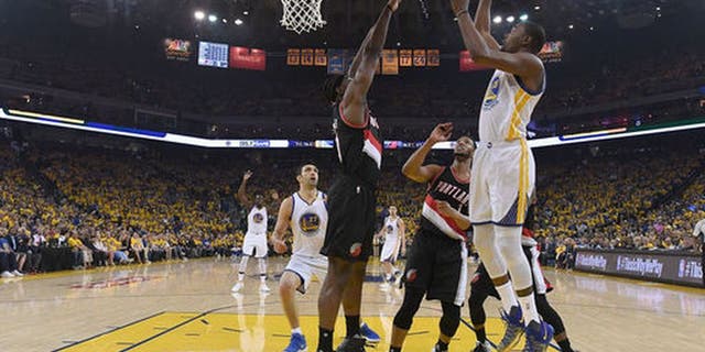 OAKLAND, CA - APRIL 16: Kevin Durant #35 of the Golden State Warriors goes up for a layup over Noah Vonleh #21 of the Portland Trail Blazers in the first quarter during Game One of the first round of the 2017 NBA Playoffs at ORACLE Arena on April 16, 2017 in Oakland, California. NOTE TO USER: User expressly acknowledges and agrees that, by downloading and or using this photograph, User is consenting to the terms and conditions of the Getty Images License Agreement. (Photo by Thearon W. Henderson/Getty Images)