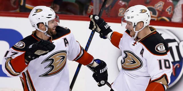 Anaheim Ducks' Corey Perry, right, celebrates his overtime goal against the Calgary Flames with Ryan Kesler during overtime in Game 3 of a first-round NHL hockey Stanley Cup playoff series in Calgary, Alberta, Monday, April 17, 2017. (Larry MacDougal/The Canadian Press via AP)