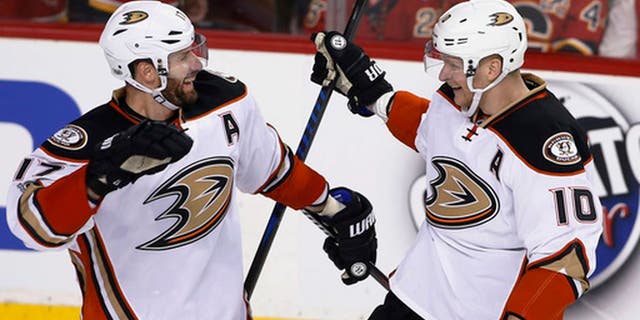 Anaheim Ducks' Corey Perry, right, celebrates his overtime goal against the Calgary Flames with Ryan Kesler during overtime in Game 3 of a first-round NHL hockey Stanley Cup playoff series in Calgary, Alberta, Monday, April 17, 2017. (Larry MacDougal/The Canadian Press via AP)