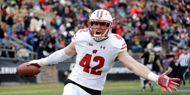 FILE - This Nov. 19, 2016, file photo shows Wisconsin linebacker T.J. Watt (42) celebrating after returning an interception for a touchdown during the first half of an NCAA college football game against the Purdue in West Lafayette, Ind. Frame to grow into a full-time defensive end, but not necessarily the athleticism to be an elite rusher. Last quarter of the first round. (AP Photo/Michael Conroy, File)