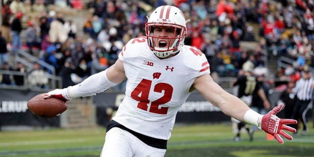 FILE - This Nov. 19, 2016, file photo shows Wisconsin linebacker T.J. Watt (42) celebrating after returning an interception for a touchdown during the first half of an NCAA college football game against the Purdue in West Lafayette, Ind. Frame to grow into a full-time defensive end, but not necessarily the athleticism to be an elite rusher. Last quarter of the first round. (AP Photo/Michael Conroy, File)