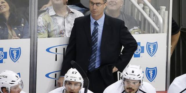 Los Angeles Kings assistant coach John Stevens stands behind his bench during the first period of an NHL hockey game against the Pittsburgh Penguins in Pittsburgh, Thursday, Oct. 30, 2014. The Penguins won 3-0. (AP Photo/Gene J. Puskar)