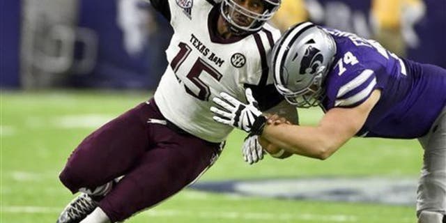 FILE - In this Dec. 28, 2016, file photo, Texas A&M's Myles Garrett (15) tries to get around Kansas State offensive lineman Scott Frantz during the second half of the Texas Bowl NCAA college football game in Houston.The NFL Draft will be held April 27-29, 2017, in Philadelphia. (AP Photo/Eric Christian Smith, File)