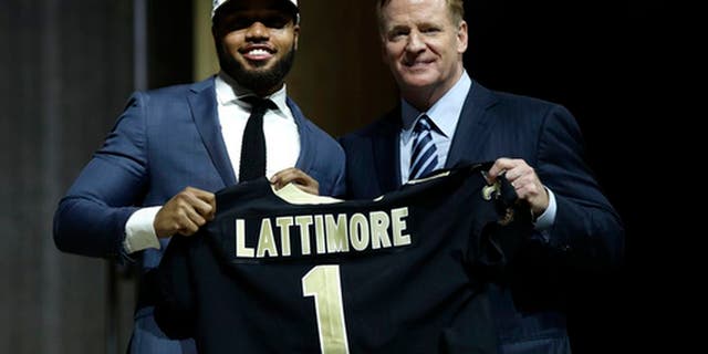 Ohio State's Marshon Lattimore, left, poses with NFL commissioner Roger Goodell after being selected by the New Orleans Saints during the first round of the 2017 NFL football draft, Thursday, April 27, 2017, in Philadelphia. (AP Photo/Matt Rourke)
