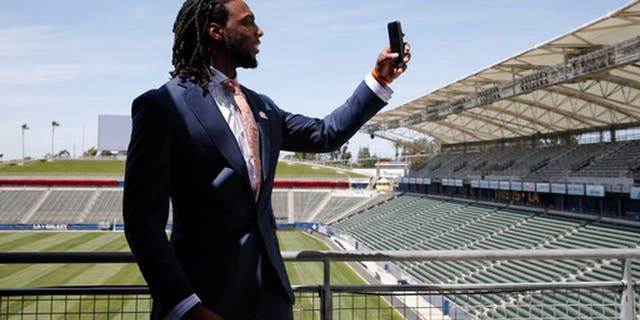 Los Angeles Chargers first-round draft pick Mike Williams records video for Snapchat after an NFL football news conference at the StubHub Center, Friday, April 28, 2017, in Carson, Calif. (AP Photo/Jae C. Hong)