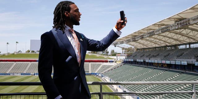 Los Angeles Chargers first-round draft pick Mike Williams records video for Snapchat after an NFL football news conference at the StubHub Center, Friday, April 28, 2017, in Carson, Calif. (AP Photo/Jae C. Hong)