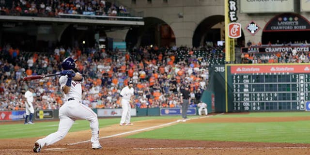 Houston Astros' Marwin Gonzalez hits a grand slam against the Texas Rangers during the eighth inning of a baseball game, Tuesday, May 2, 2017, in Houston. (AP Photo/David J. Phillip)