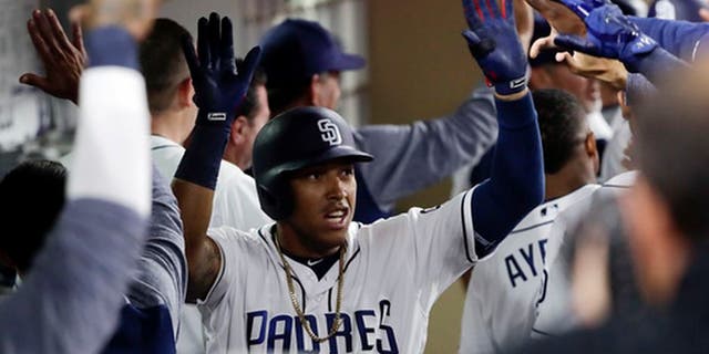 San Diego Padres' Yangervis Solarte is greeted by teammates in the dugout after his two-run home run during the sixth inning of a baseball game against the Colorado Rockies on Tuesday, May 2, 2017, in San Diego. (AP Photo/Gregory Bull)