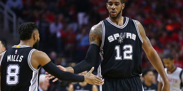 HOUSTON, TX - MAY 11: LaMarcus Aldridge #12 of the San Antonio Spurs reacts with Patty Mills #8 against the Houston Rockets during Game Six of the NBA Western Conference Semi-Finals at Toyota Center on May 11, 2017 in Houston, Texas. NOTE TO USER: User expressly acknowledges and agrees that, by downloading and or using this photograph, User is consenting to the terms and conditions of the Getty Images License Agreement. (Photo by Ronald Martinez/Getty Images)