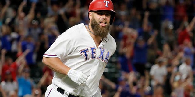 Texas Rangers' Mike Napoli celebrates as he runs the bases after hitting a game-winning three-run home run off San Diego Padres reliever Brandon Maurer during the ninth inning of a baseball game, Thursday, May 11, 2017, in Arlington, Texas. The Rangers won 5-2. (AP Photo/Tony Gutierrez)