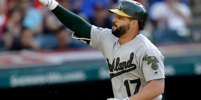 Oakland Athletics' Yonder Alonso points after hitting a solo home run off Cleveland Indians starting pitcher Carlos Carrasco in the seventh inning of a baseball game, Monday, May 29, 2017, in Cleveland. (AP Photo/Tony Dejak)
