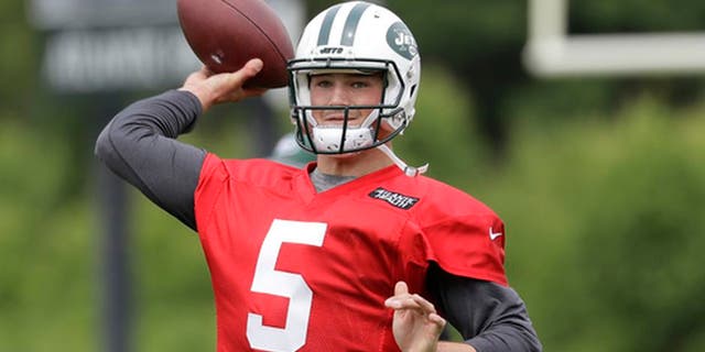 FILE - In this May 23, 2017, file photo, New York Jets' Christian Hackenberg throws a pass during the team's organized team activities at its NFL football training facility in Florham Park, N.J. The Jets would like to see Hackenberg take charge in the team's quarterback competition. But with the 2016 second-round draft pick out of Penn State still considered a project after not playing at all last season, it remains uncertain whether Hackenberg will progress enough to be the starter this year. (AP Photo/Julio Cortez, File)