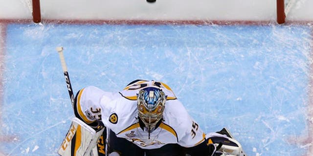 A shot by Pittsburgh Penguins' Justin Schultz gets past Nashville Predators goalie Pekka Rinne (35) for a goal during the first period of Game 5 of the NHL Stanley Cup Final, Thursday, June 8, 2017, in Pittsburgh. (AP Photo/Gene J. Puskar)