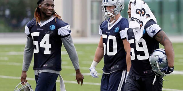 Dallas Cowboys' Jaylon Smith (54), Sean Lee (50) and Anthony Hitchens (59) walk off the practice field after NFL football practice at the team's training facility, Tuesday, June 13, 2017, in Frisco, Texas. Lee is surrounded by uncertainty on a Dallas defense needing improvement to match a dynamic offense that carried the Cowboys to the best record in the NFC last year. The All-Pro linebacker is a pretty good starting point. (AP Photo/Tony Gutierrez)