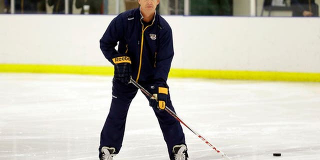 Nashville Predators assistant coach Phil Housley watches players at NHL hockey training camp Friday, Sept. 18, 2015, in Nashville, Tenn. (AP Photo/Mark Humphrey)