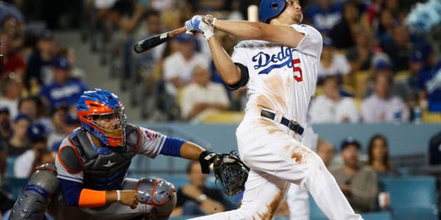 Los Angeles Dodgers' Corey Seager watches his third home run of the night, during the fifth inning of the team's baseball game against the New York Mets, Tuesday, June 20, 2017, in Los Angeles. (AP Photo/Jae C. Hong)