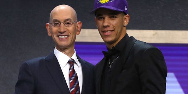 Lonzo Ball walks on stage with NBA commissioner Adam Silver after being drafted second overall by the Los Angeles Lakers during the first round of the 2017 NBA Draft at Barclays Center June 22, 2017, in New York City.