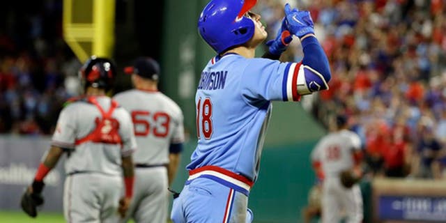 Texas Rangers' Drew Robinson (18) points skyward as he approaches the plate after hitting a two-run home run off Los Angeles Angels relief pitcher Blake Parker (53) during the sixth inning of a baseball game, Saturday, July 8, 2017, in Arlington, Texas. (AP Photo/Tony Gutierrez)
