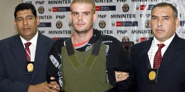 June 5: Joran van der Sloot is escorted by Peruvian police as he arrives at their offices in Lima.