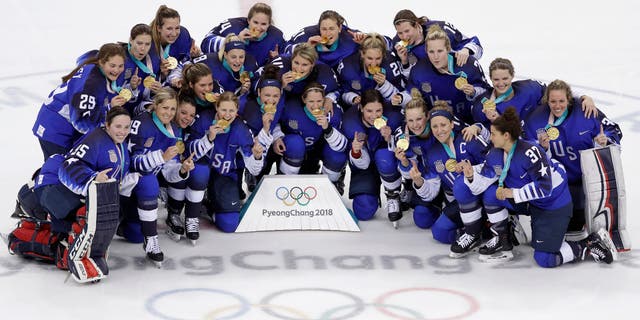 United States hockey team celebrate with their gold medals after beating Canada in the women's gold medal hockey game at the 2018 Winter Olympics in South Korea on Thursday, Feb. 22, 2018. 