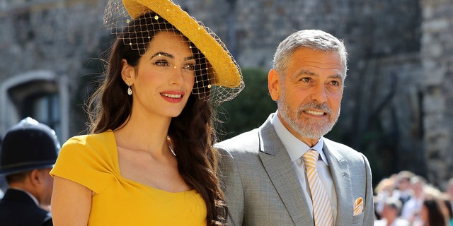 Amal Clooney and George Clooney arrive for the wedding ceremony of Prince Harry and Meghan Markle at St. George's Chapel in Windsor Castle in Windsor, near London, England, Saturday, May 19, 2018. (Gareth Fuller/pool photo via AP)