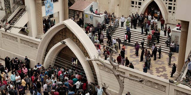Sunday, April 9, 2017: People gather outside the St. George's Church after a deadly suicide bombing, in the Nile Delta town of Tanta, Egypt.
