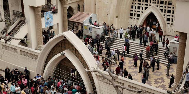 Sunday, April 9, 2017: People gather outside the St. George's Church after a deadly suicide bombing, in the Nile Delta town of Tanta, Egypt.