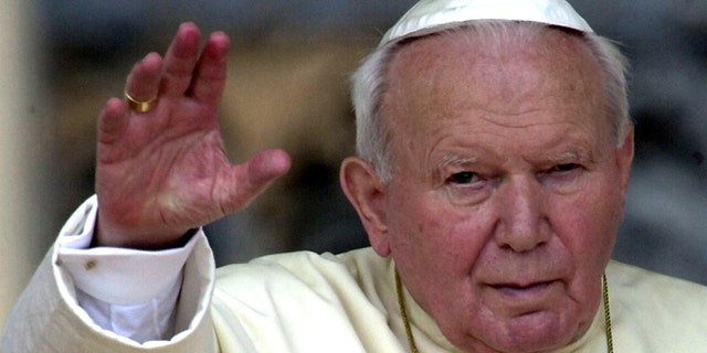In this May 2, 2001 file photo, Pope John Paul II waves to faithfuls gathered for the weekly general audience at St. Peter's Square in the Vatican.