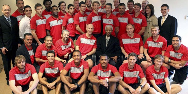 The U.S. mens national soccer team pose for a group picture with former Sou0th African President Nelson Mandela (C) at his office in Houghton, Johannesburg, November 18, 210.