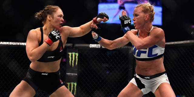 MELBOURNE, AUSTRALIA - NOVEMBER 15: (L-R) Ronda Rousey faces Holly Holm in their UFC women's bantamweight championship bout during the UFC 193 event at Etihad Stadium on November 15, 2015 in Melbourne, Australia. (Photo by Jeff Bottari/Zuffa LLC/Zuffa LLC via Getty Images)