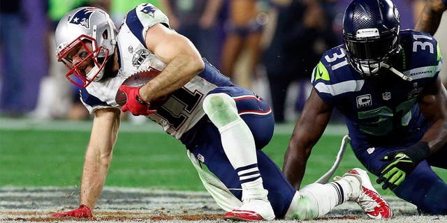 Feb 1, 2015; Glendale, AZ, USA; New England Patriots wide receiver Julian Edelman (11) is tackled by Seattle Seahawks strong safety Kam Chancellor (31) during the fourth quarter in Super Bowl XLIX at University of Phoenix Stadium. Mandatory Credit: Matthew Emmons-USA TODAY Sports