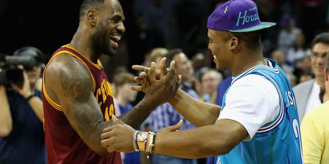 CHARLOTTE, NC - NOVEMBER 27: (L-R) LeBron James #23 of the Cleveland Cavaliers talks to Cam Newton, quarterback of the Carolina Panthers after the Cavaliers defeated the Hornets 95-90 at Time Warner Cable Arena on November 27, 2015 in Charlotte, North Carolina. NBA - NOTE TO USER: User expressly acknowledges and agrees that, by downloading and or using this photograph, User is consenting to the terms and conditions of the Getty Images License Agreement. (Photo by Streeter Lecka/Getty Images)