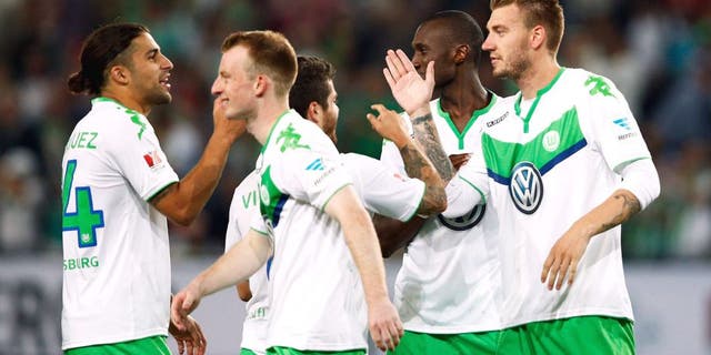 WOLFSBURG, GERMANY - AUGUST 01: Nicklas Bendtner of VfL Wolfsburg is congratulated by team mates after he scores the winning penalty in the shoot out during the DFL Supercup match between VfL Wolfsburg and FC Bayern Muenchen at Volkswagen Arena on August 1, 2015 in Wolfsburg, Germany. (Photo by Dean Mouhtaropoulos/Bongarts/Getty Images)