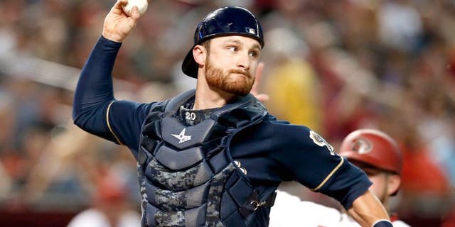 Jul 24, 2015; Phoenix, AZ, USA; Milwaukee Brewers catcher Jonathan Lucroy (20) turns the double play while avoiding Arizona Diamondbacks right fielder Ender Inciarte (5) in the third inning at Chase Field. Mandatory Credit: Rick Scuteri-USA TODAY Sports