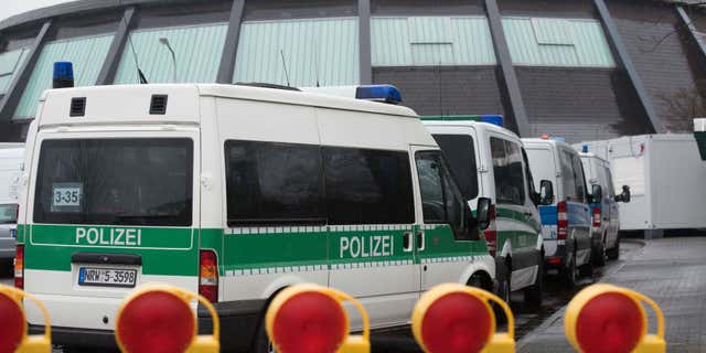 Feb. 4, 2016: Police vehicles park in front of the reception facility for refugees located in a gymnasium in Attendorn, Germany.