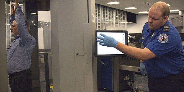 Feb. 1: Transportation Security Administration supervisor Nick Fox, right, demonstrates new software being tested with advanced imaging technology at McCarran International Airport in Las Vegas.