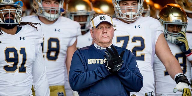 Nov 28, 2015; Stanford, CA, USA; Notre Dame Fighting Irish head coach Brian Kelly leads his team onto the field against the Stanford Cardinal at Stanford Stadium. Stanford won 38-36.Mandatory Credit: Matt Cashore-USA TODAY Sports