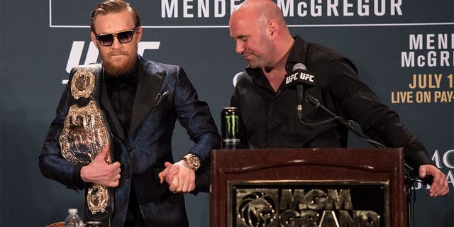 LAS VEGAS, NV - JULY 11: UFC President Dana White (R) greets UFC interim featherweight champion Conor McGregor during the UFC 189 post fight press conference at the MGM Grand Garden Arena on July 11, 2015 in Las Vegas, Nevada. (Photo by Jeff Bottari/Zuffa LLC/Zuffa LLC via Getty Images)
