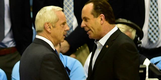 Jan 5, 2015; Chapel Hill, NC, USA; North Carolina Tar Heels head coach Roy Williams and Notre Dame Fighting Irish head coach Mike Brey greet each other before the game at Dean E. Smith Center. Mandatory Credit: Bob Donnan-USA TODAY Sports