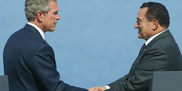 In a June 3, 2003 file photo, U.S. President George W. Bush shakes hands with Egyptian President Hosni Mubarak during the Multilateral Summit in Sharm El-Sheikh, Egypt.