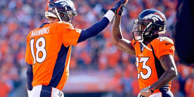 Jan 24, 2016; Denver, CO, USA; Denver Broncos quarterback Peyton Manning (18) celebrates with running back Ronnie Hillman (23) during the game against the New England Patriots in the AFC Championship football game at Sports Authority Field at Mile High. Mandatory Credit: Kevin Jairaj-USA TODAY Sports