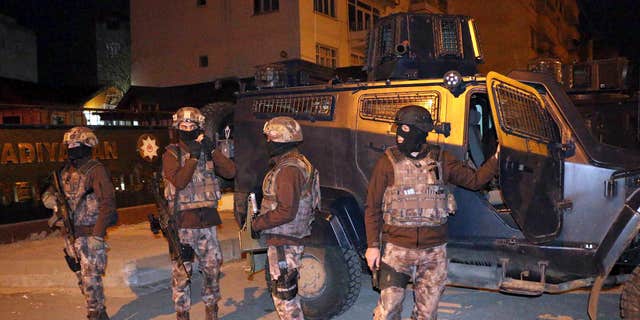 Feb. 5, 2017: Turkish anti-terrorism police stand by their armoured vehicle during an operation to arrest people over alleged links to the Islamic State group, in Adiyaman, southeastern Turkey.