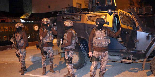 Feb. 5, 2017: Turkish anti-terrorism police stand by their armoured vehicle during an operation to arrest people over alleged links to the Islamic State group, in Adiyaman, southeastern Turkey.